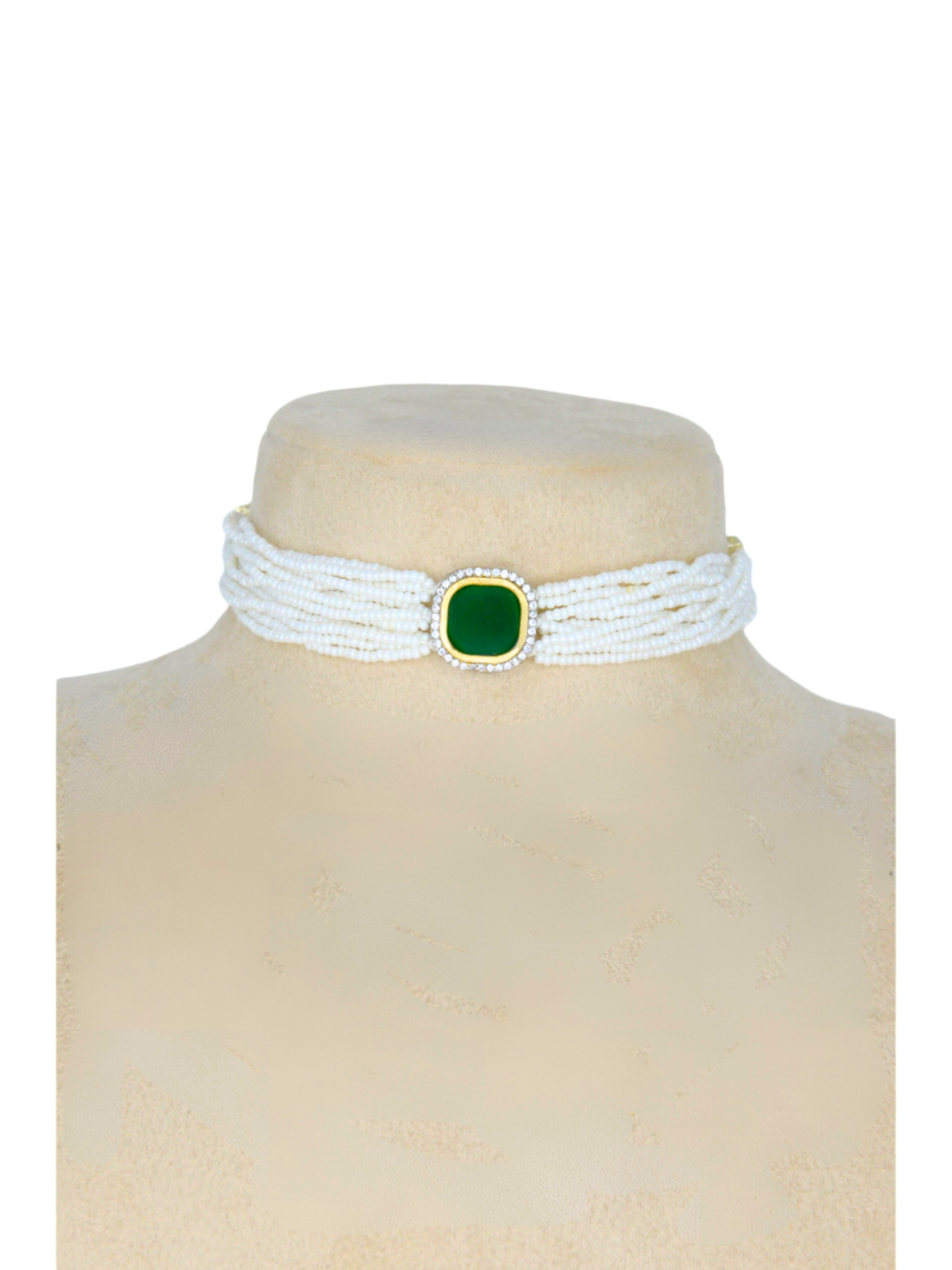 Pearl necklace with central green gemstone on a buck.