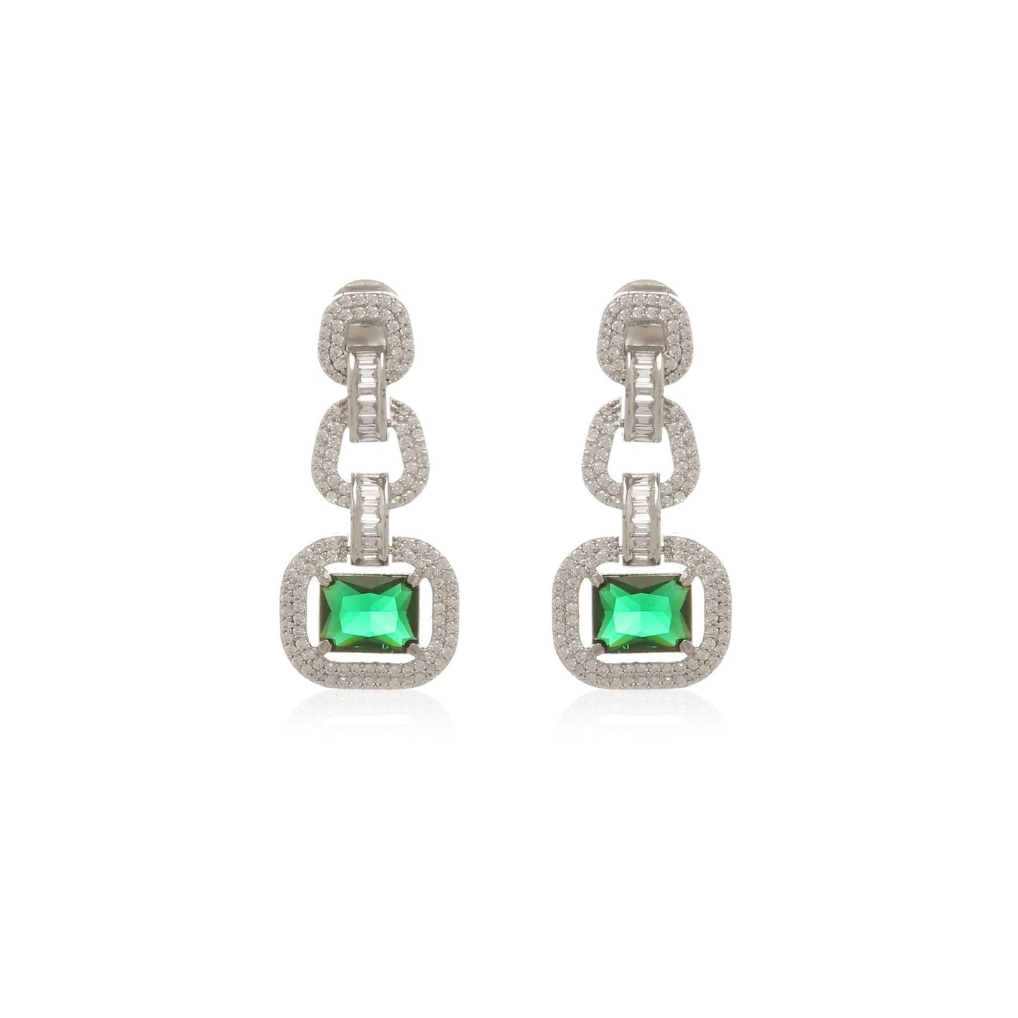 Pair of elegant white gold earrings with green gemstones on a white background