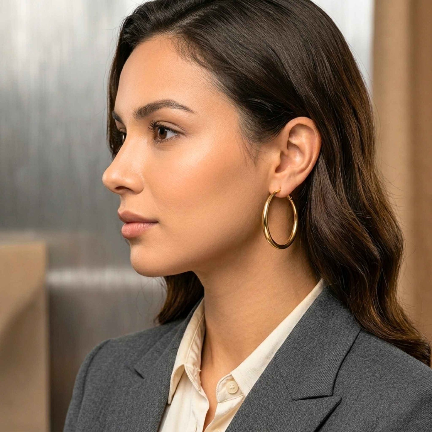 Woman looking to the side with a large gold hoop. Digitally rendered model for scale