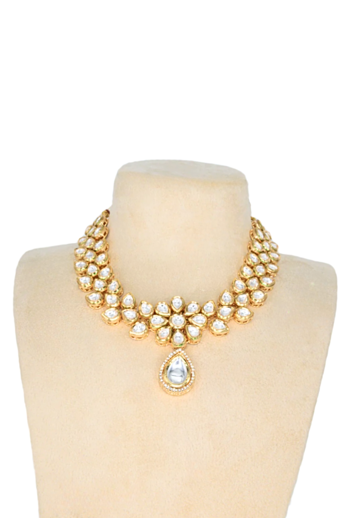 Gold necklace choker with floral and petal design on a busk against a white background