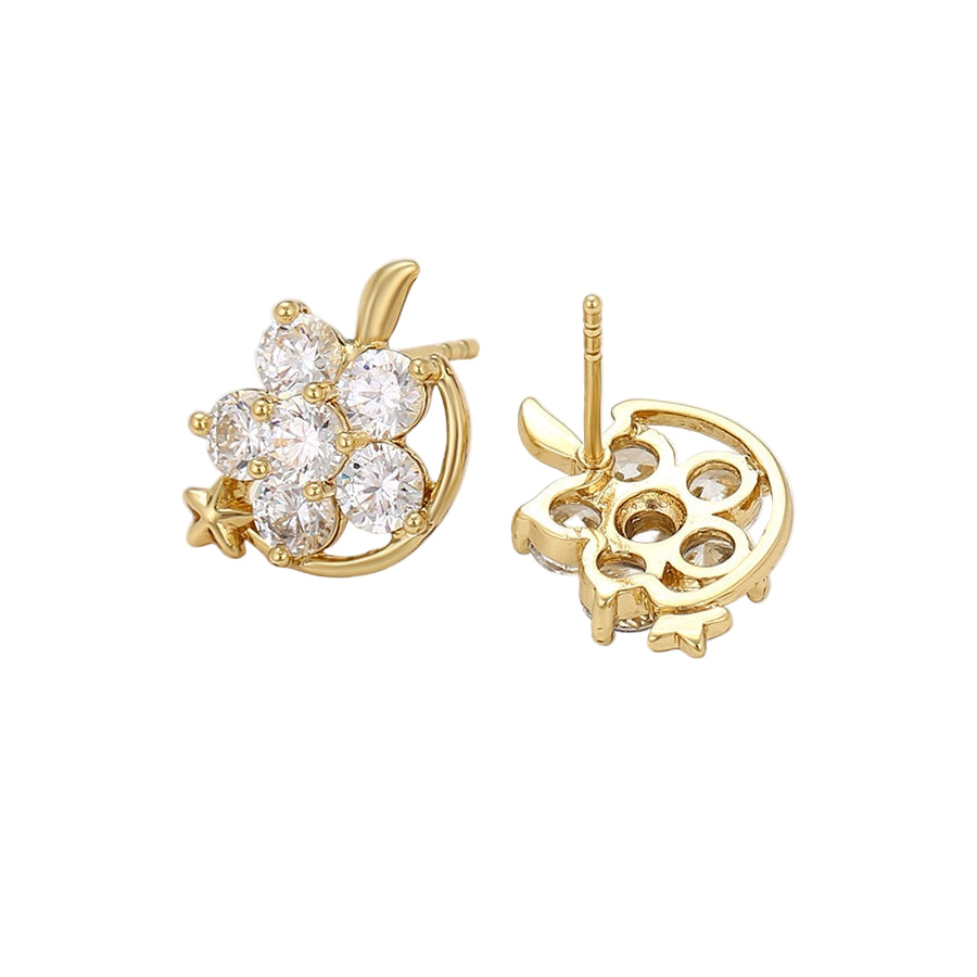 Gold star earrings with clear gemstones on a light background