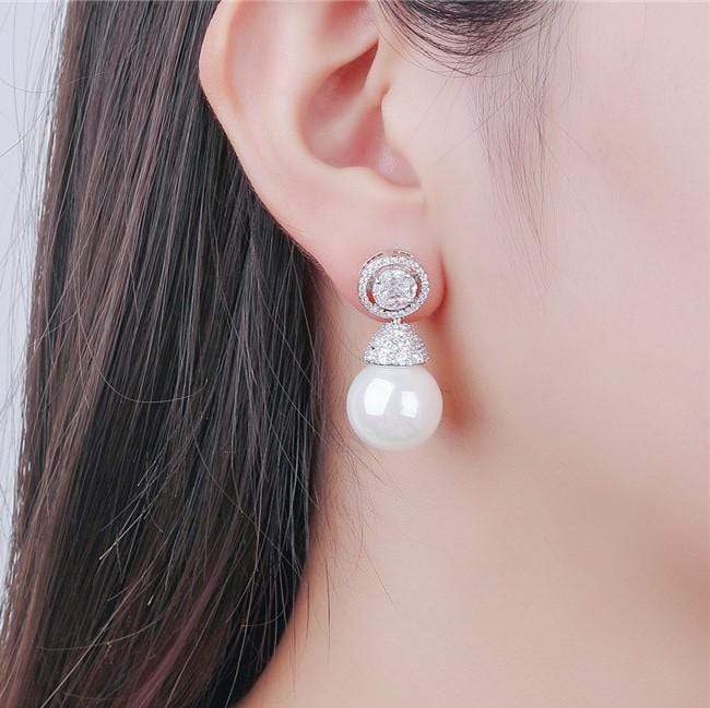 Pearl earring worn by a person with a neutral background