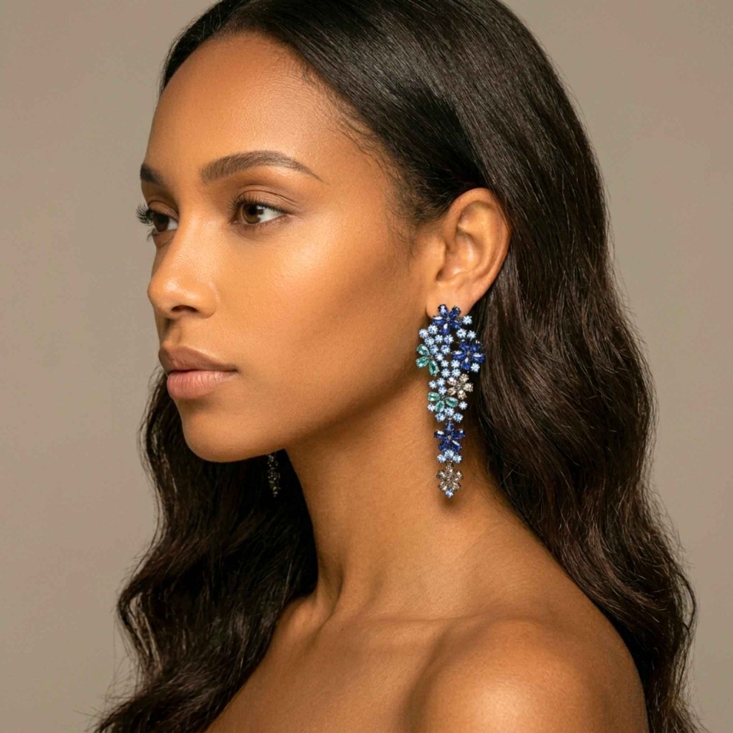 Side shot of a woman wearing multicoloured earrings. Digitally rendered model for scale.