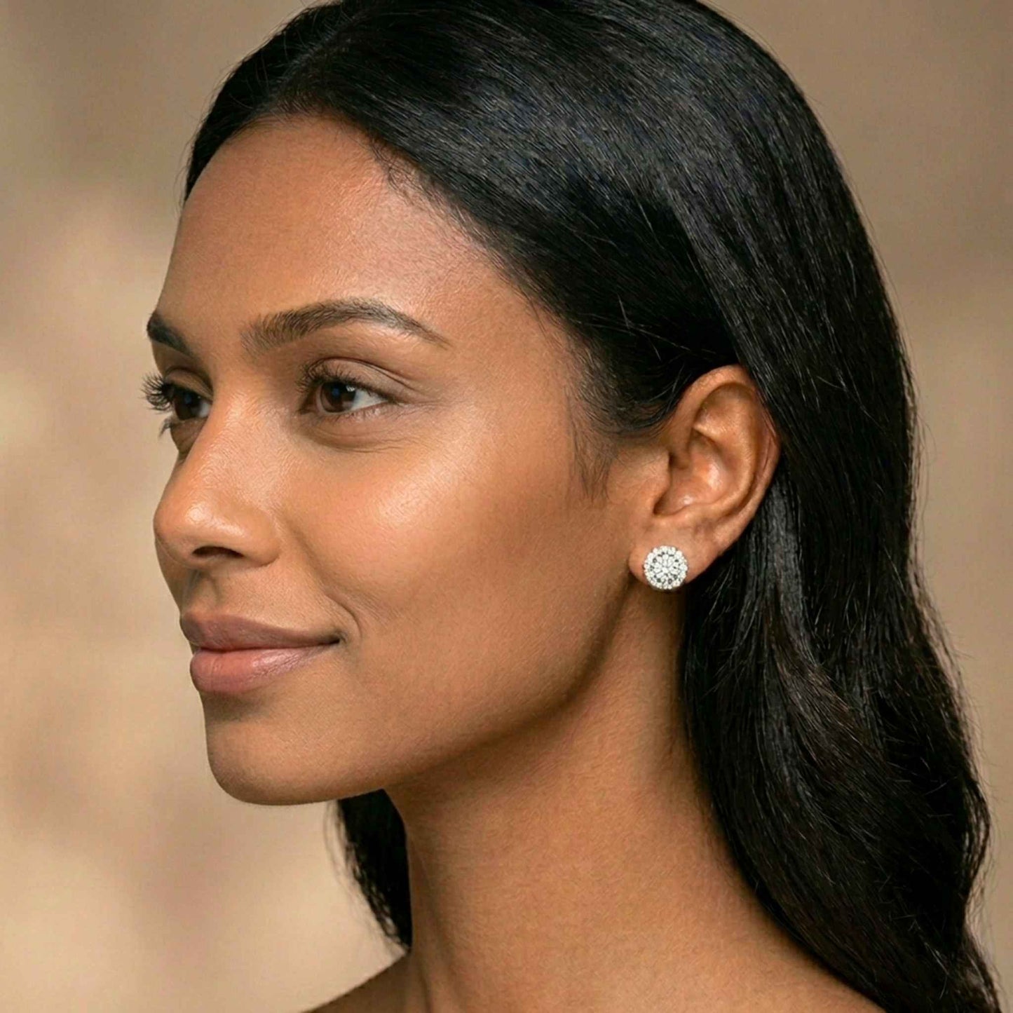 Woman wearing diamond stud earrings with a neutral background. Digitally rendered model for scale