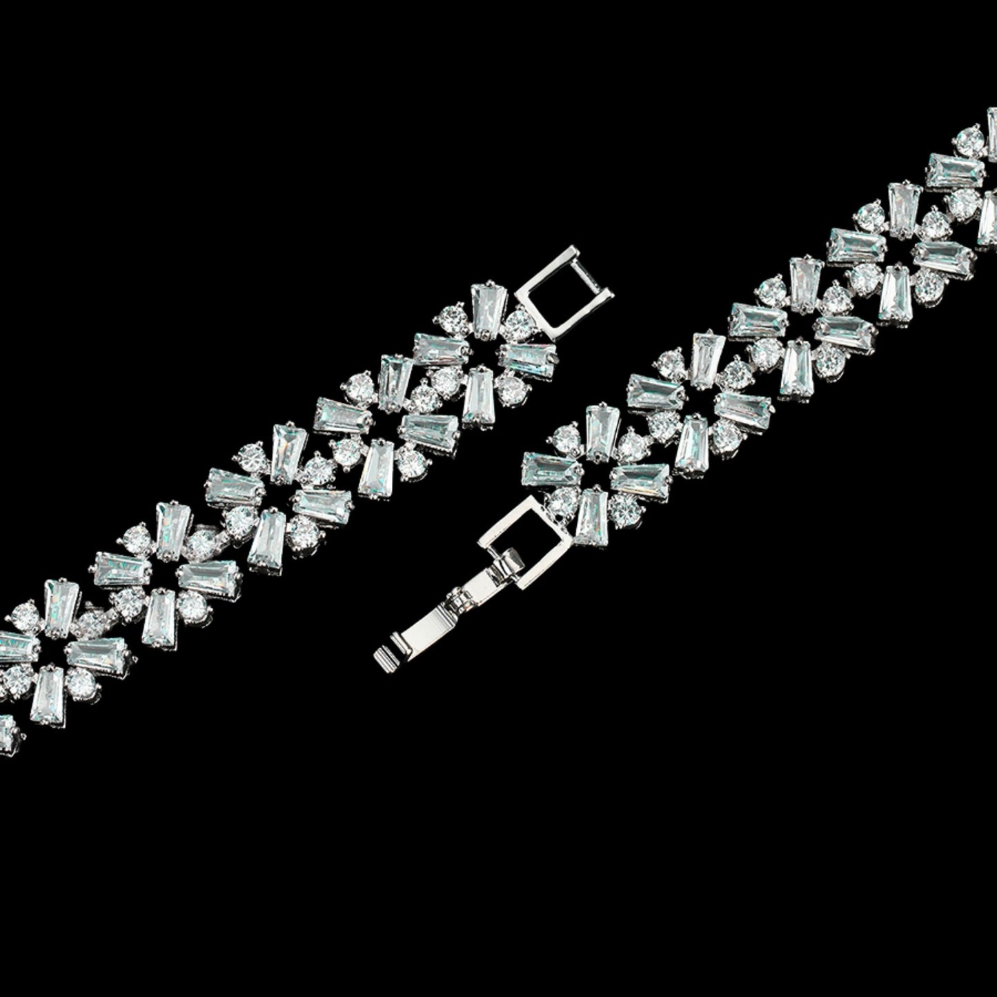 Close up of a charming white gold plated link bracelet featuring contemporary geometric floral-style links embedded with shimmering baguette and round cubic zirconia from the Jewellery 4 Elegance collection.