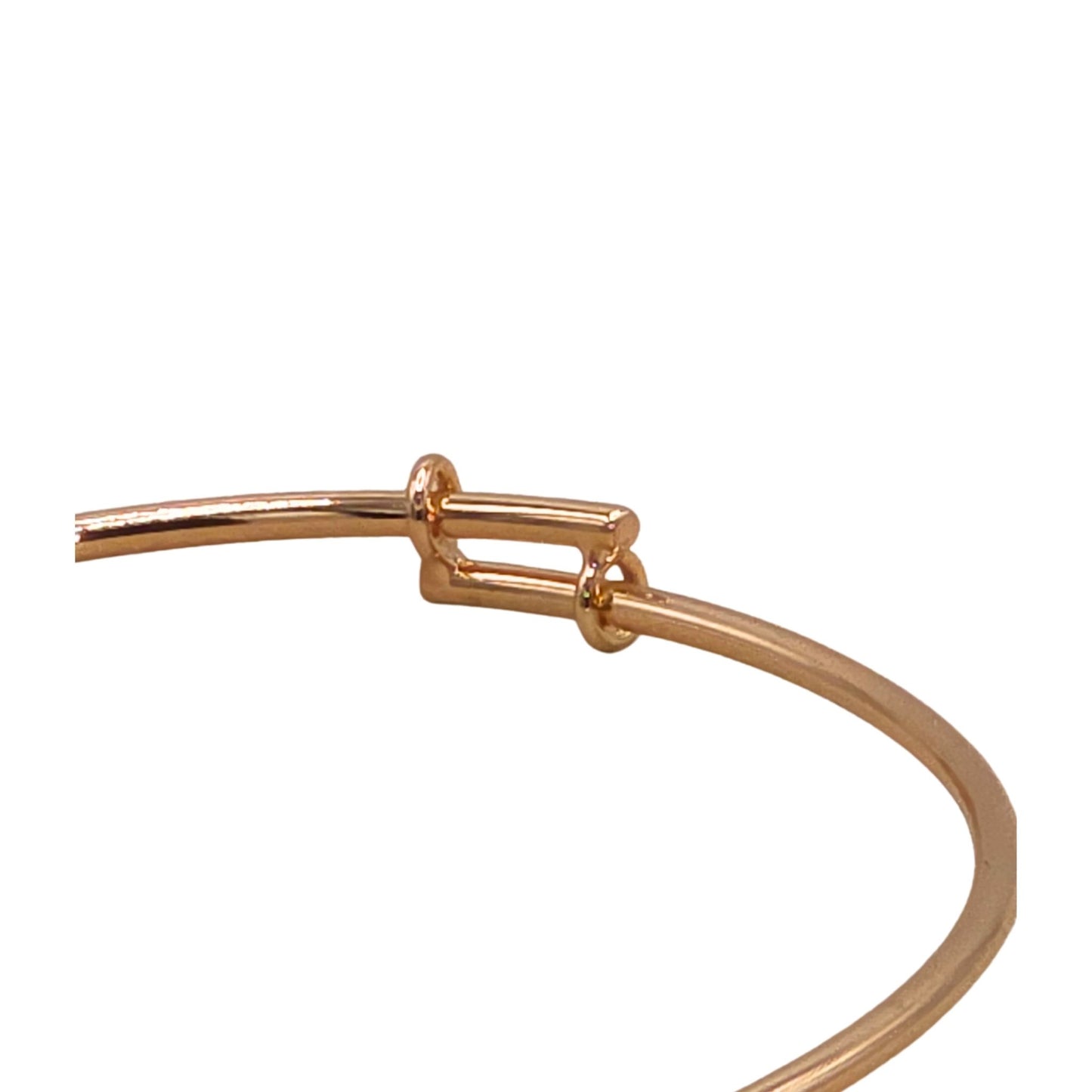 Rose gold bangle bracelet on a white background