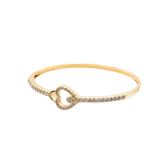 18k gold plated bangle bracelet with a pavé cubic zirconia heart centrepiece and a concealed integrated snap closure on a white background