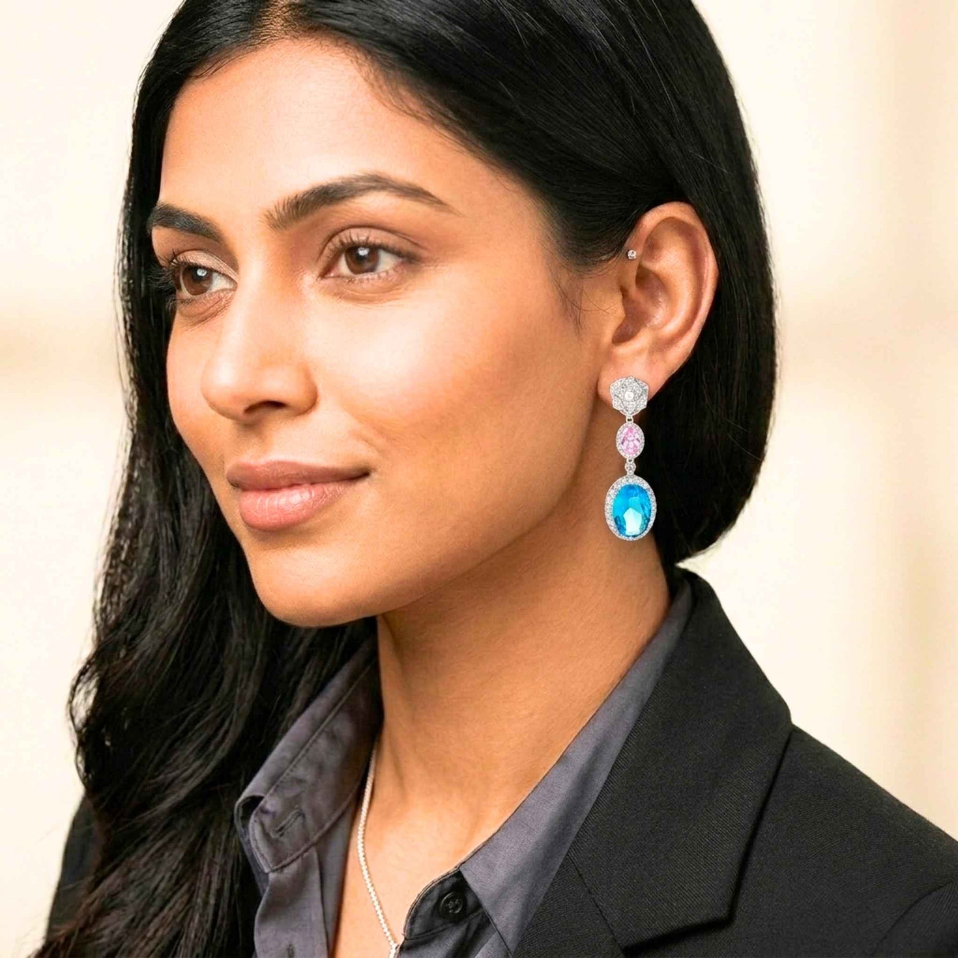 Woman wearing colourful earrings with a neutral background.  Digitally rendered model for scale.