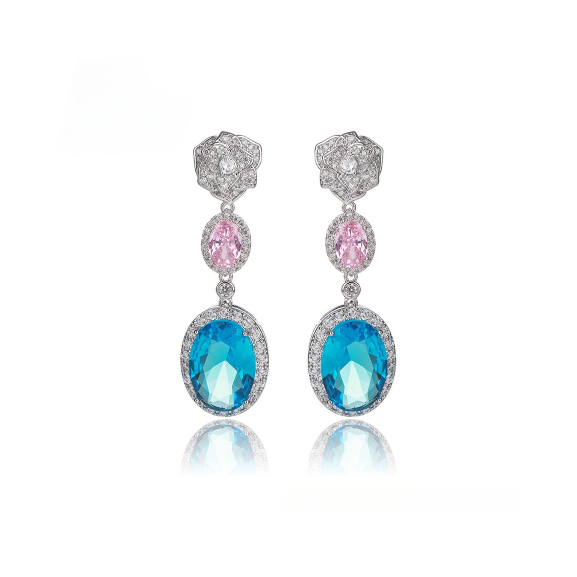 Pair of earrings with blue and pink gemstones on a white background