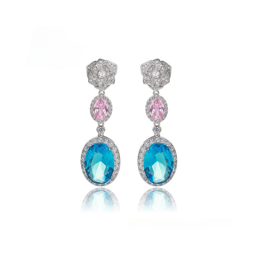 Pair of earrings with blue and pink gemstones on a white background