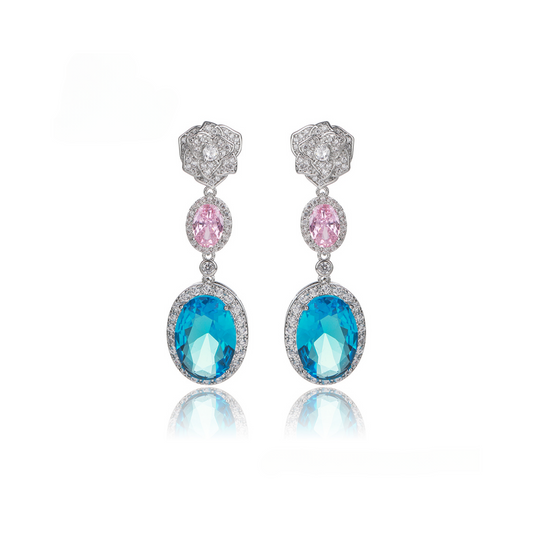 Pair of earrings with blue and pink gemstones on a white background