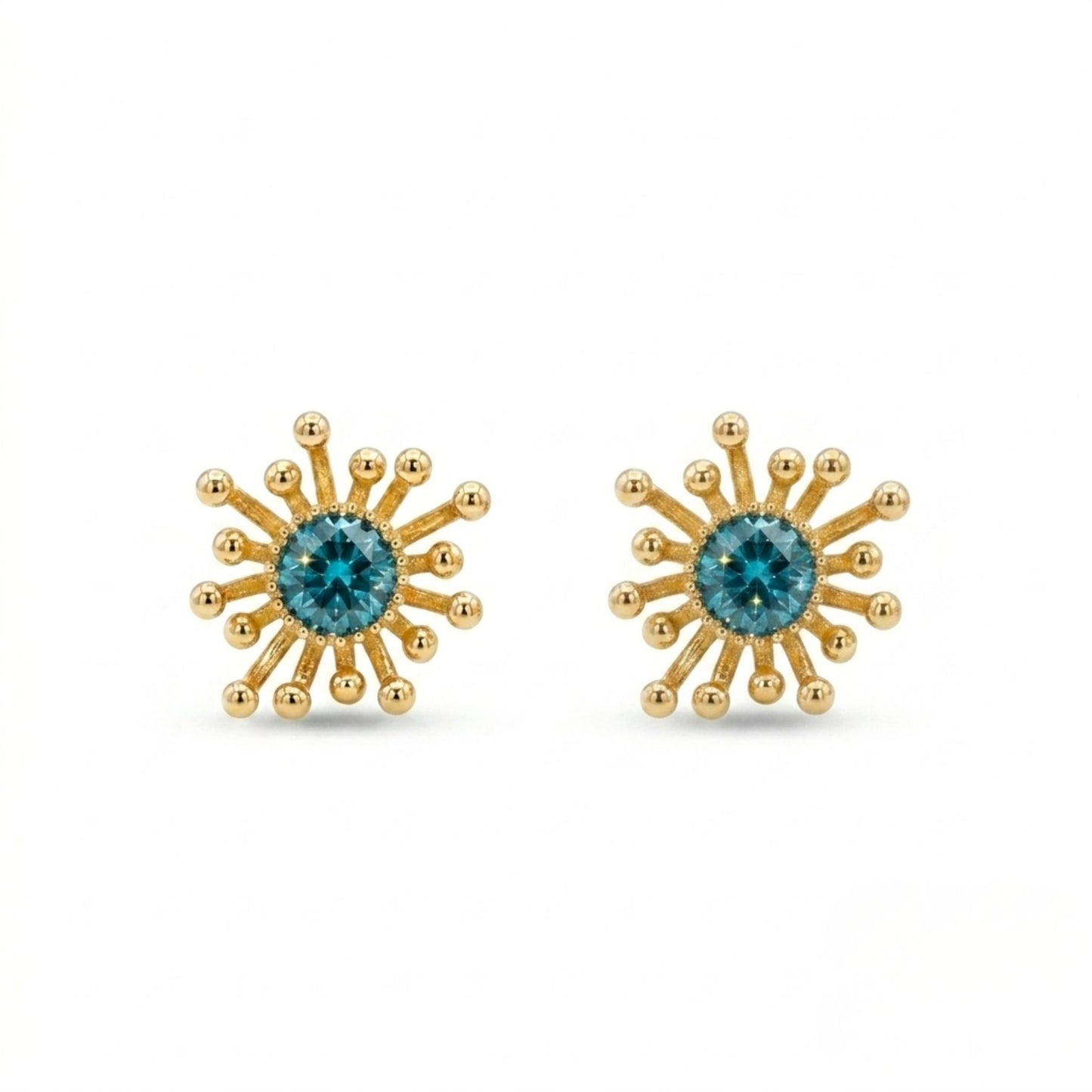 Gold sunburst earrings with blue gemstones on a white background