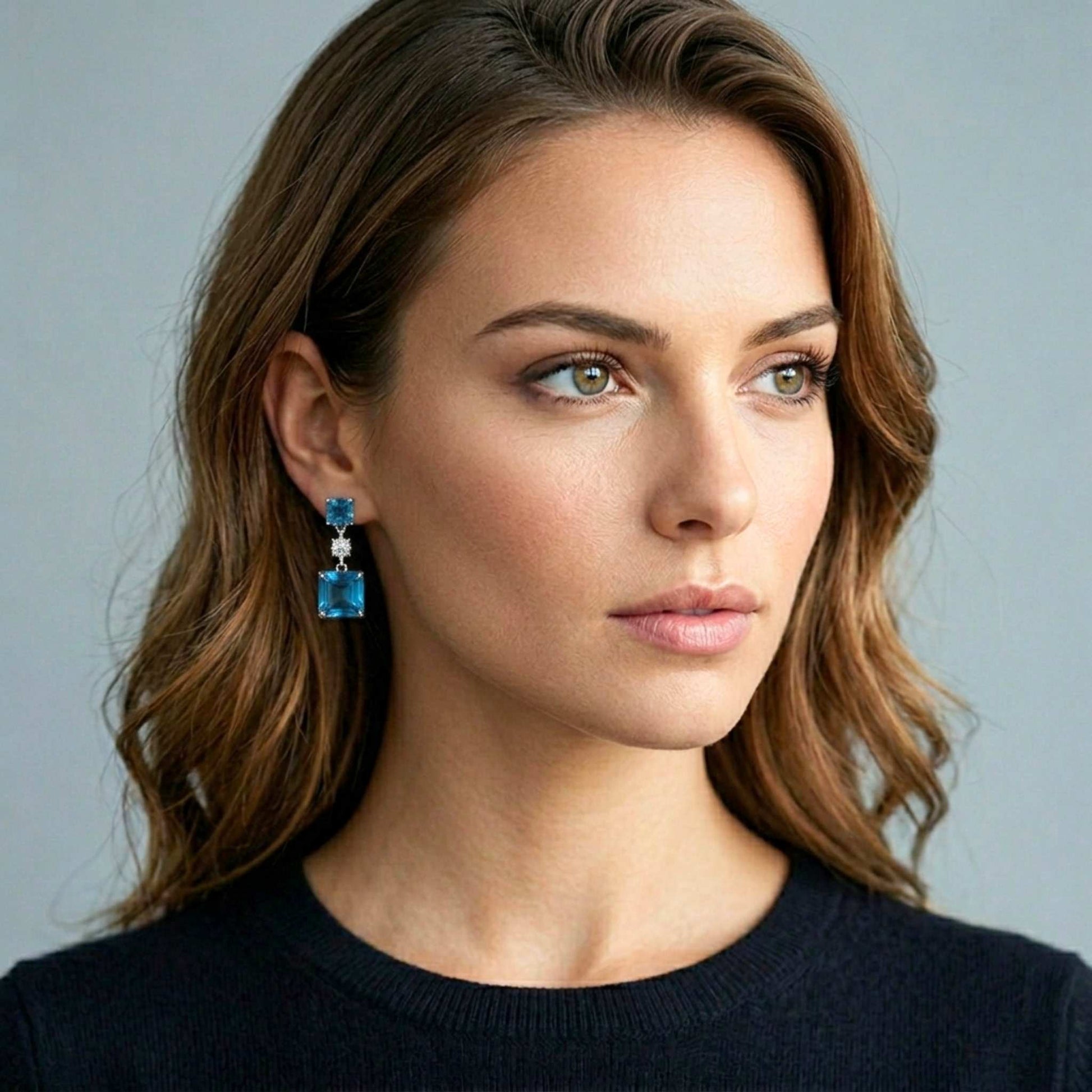 Attractive woman wearing blue sapphire earrings.  Digitally rendered model for scale.