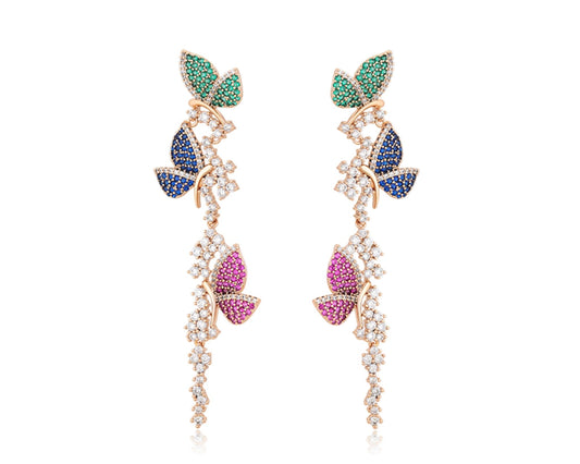 Pair of butterfly-shaped earrings with gemstones on a white background