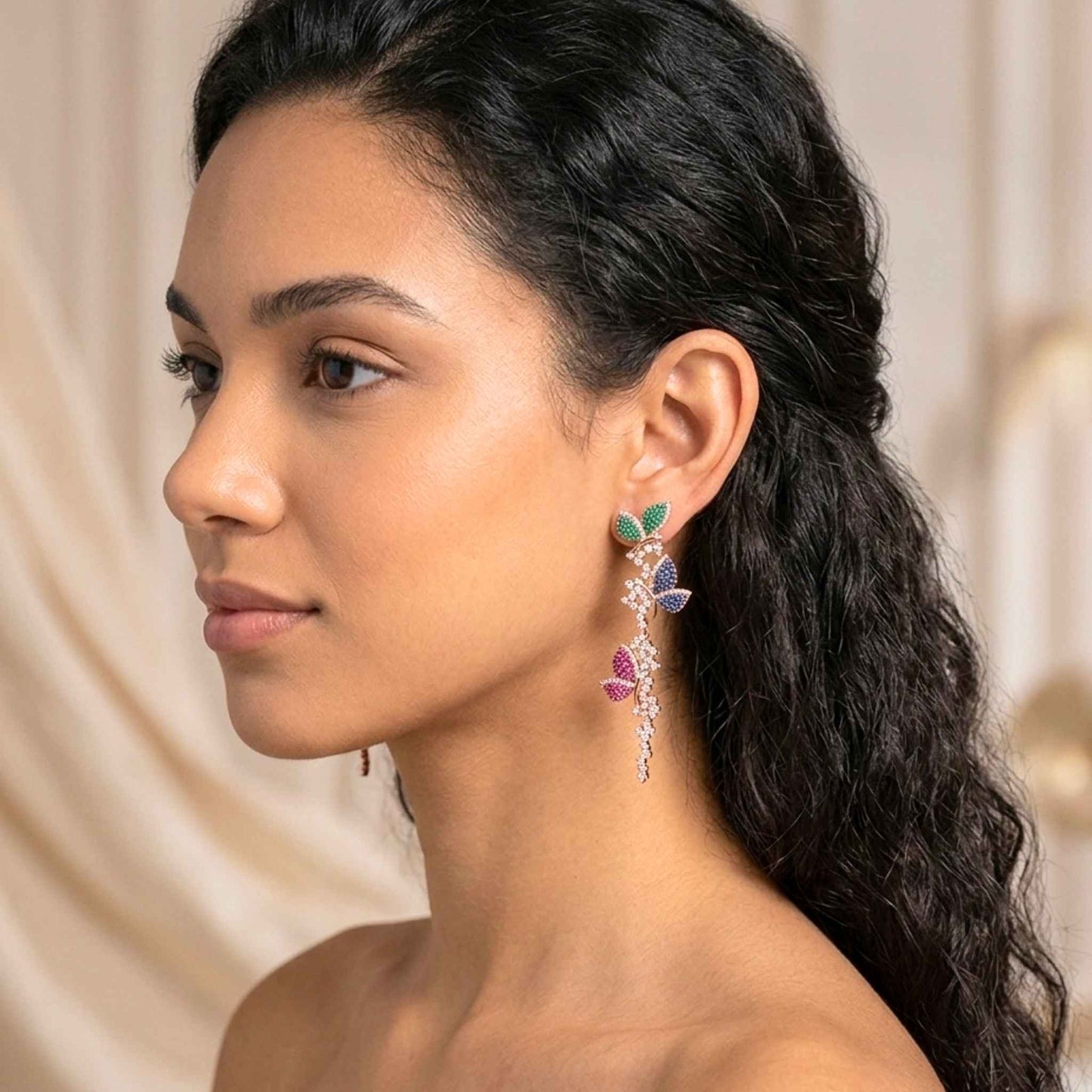 Woman wearing colourful butterfly earrings with a neutral background.  Digitally rendered model for scale