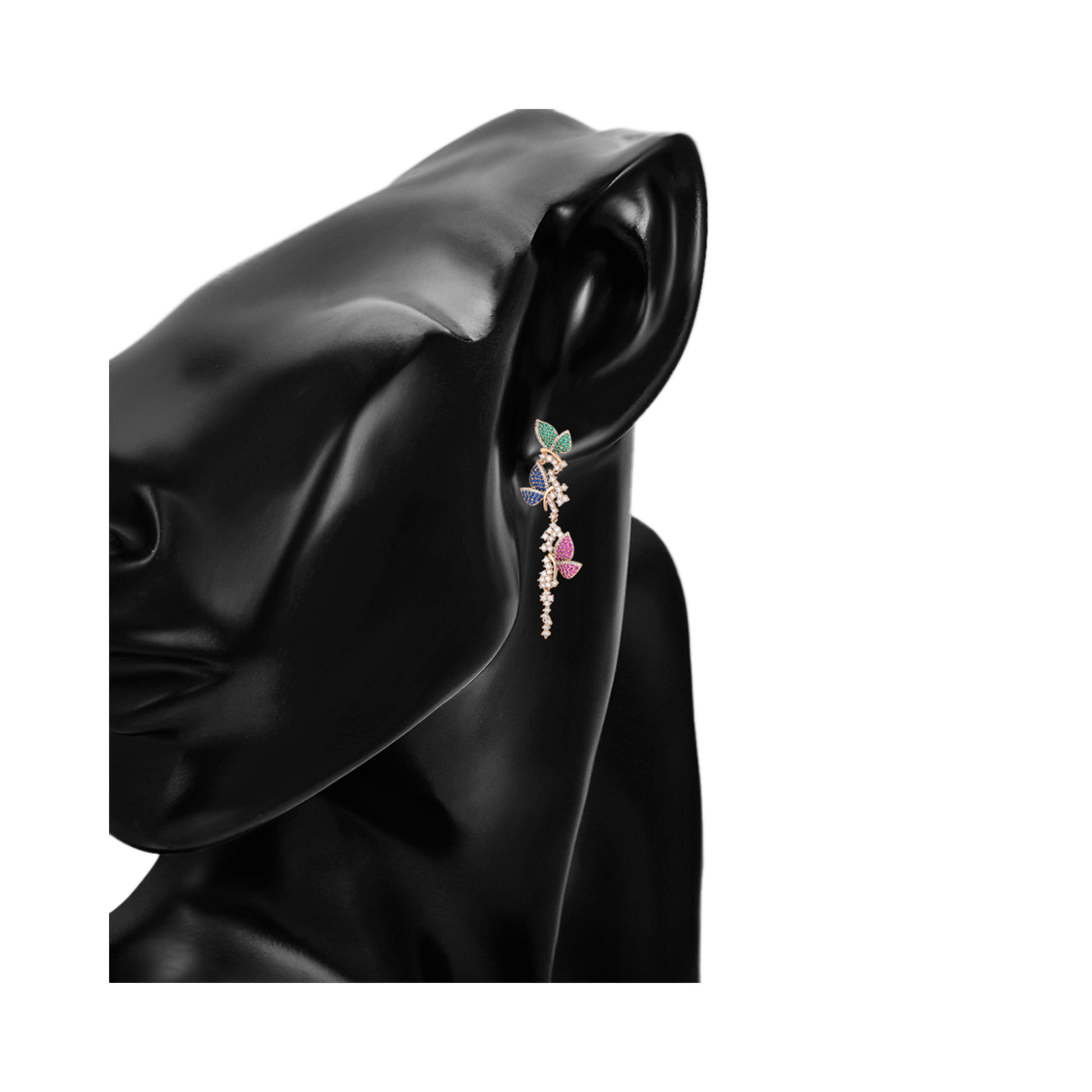 Butterfly earring worn on a mode against a white background