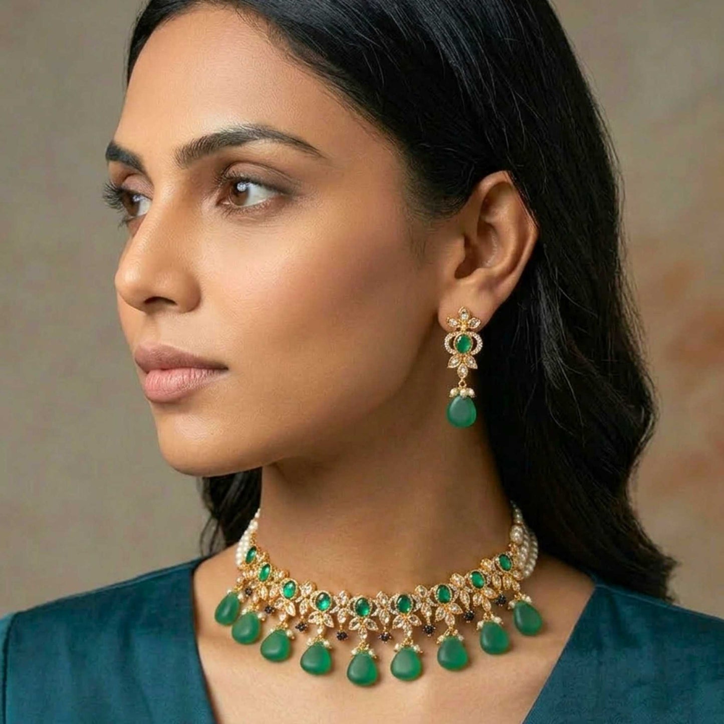 Woman wearing a green and gold necklace and earrings against a neutral background.  Digitally rendered model for scale.
