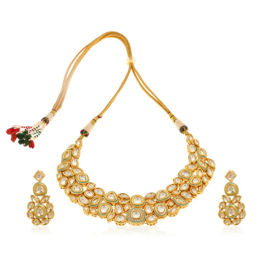 Gold necklace with matching earrings  in an Indian style with mint hue colour finish on a white background