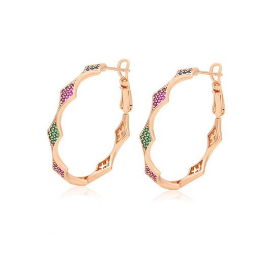 Gold hoop earrings with red green and blue zirconia on white background