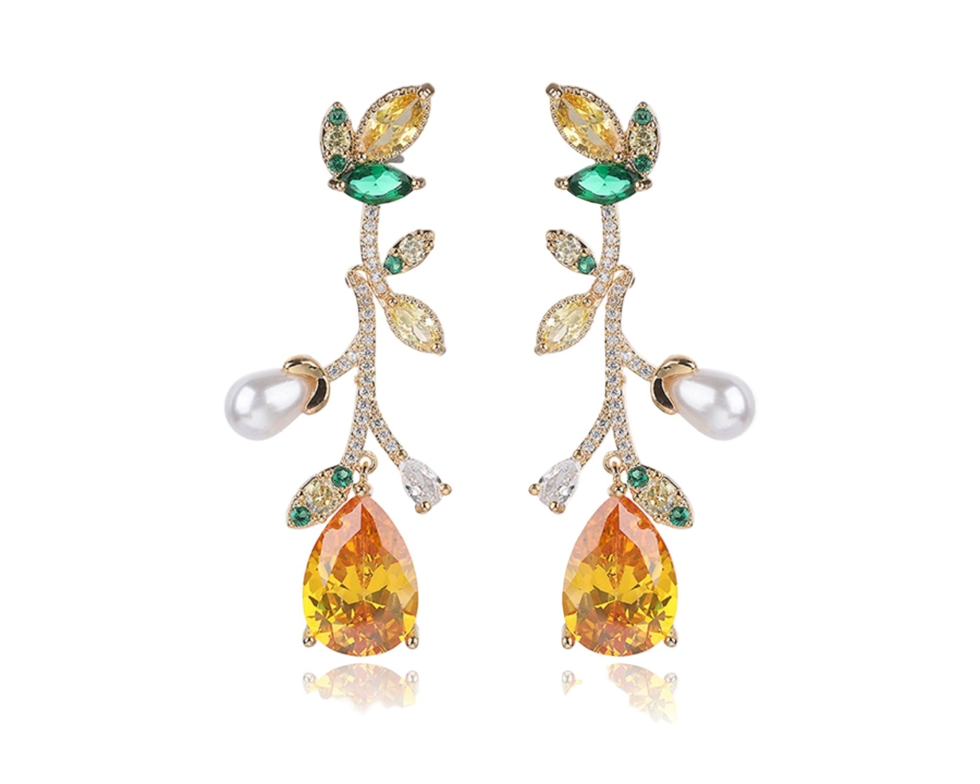 Pair of earrings with yellow and green gemstones on a white background