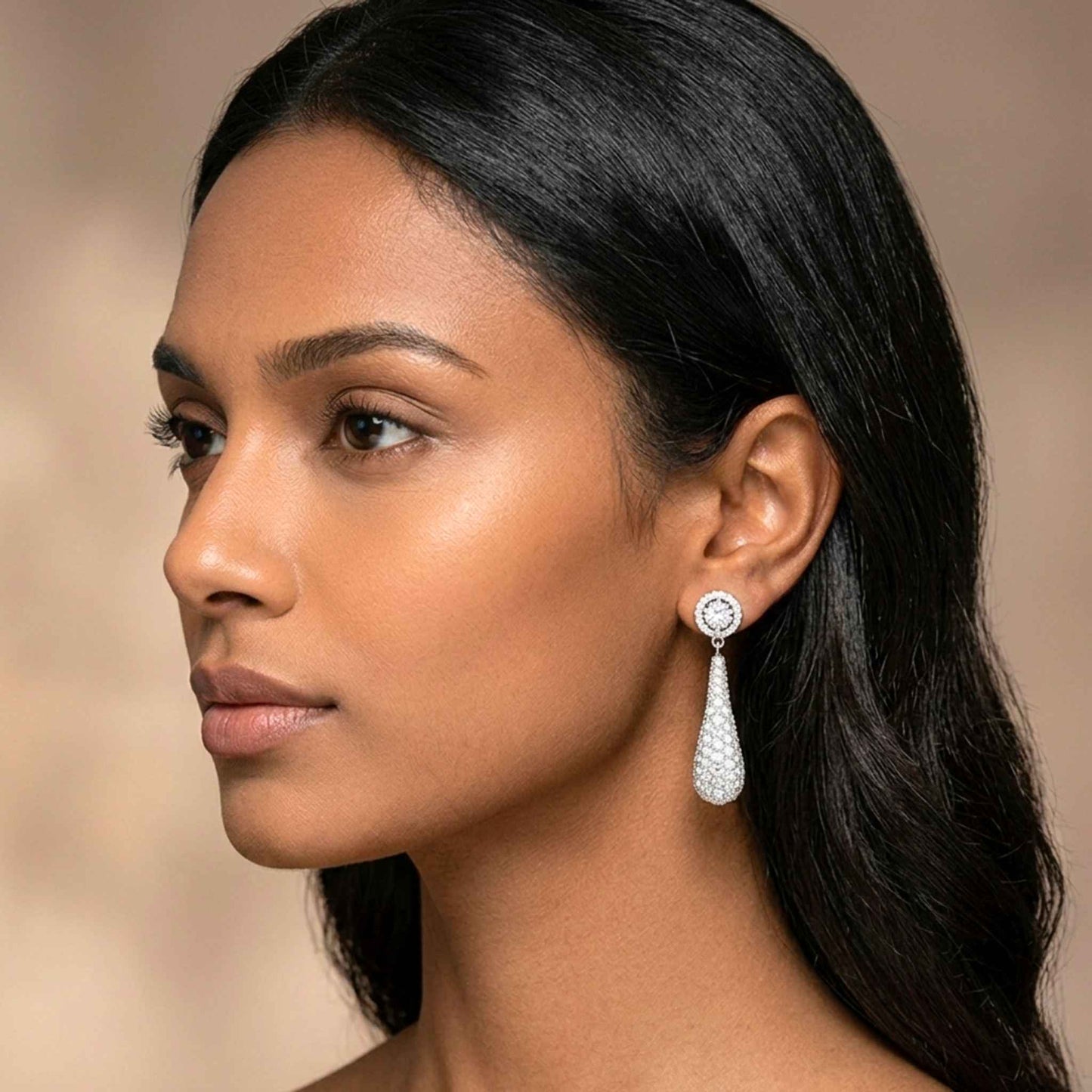 Close-up of a woman wearing a diamond earring with a blurred background.  Digitally rendered model for scale