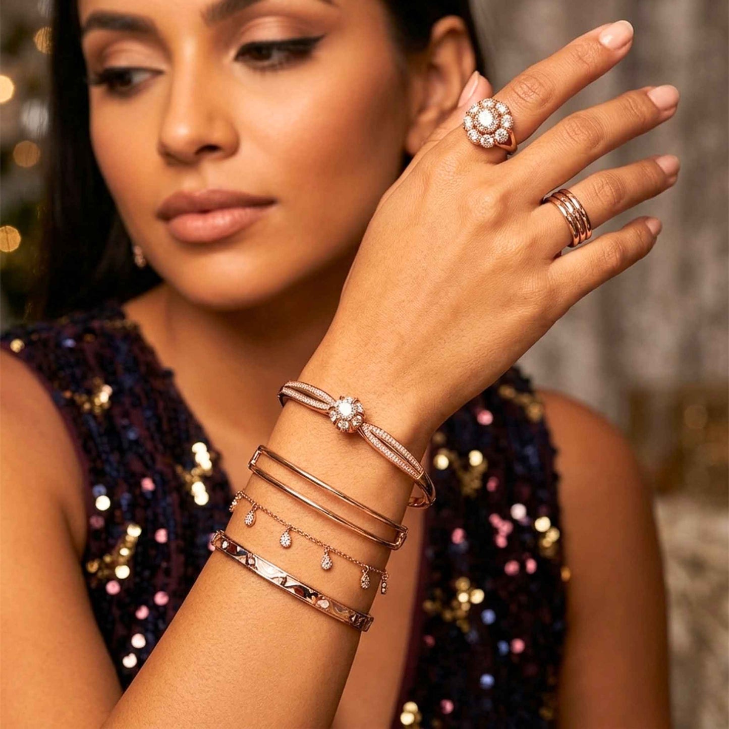 Woman wearing multiple bracelets and rings on a blurred background.  Digitally rendered model for scale