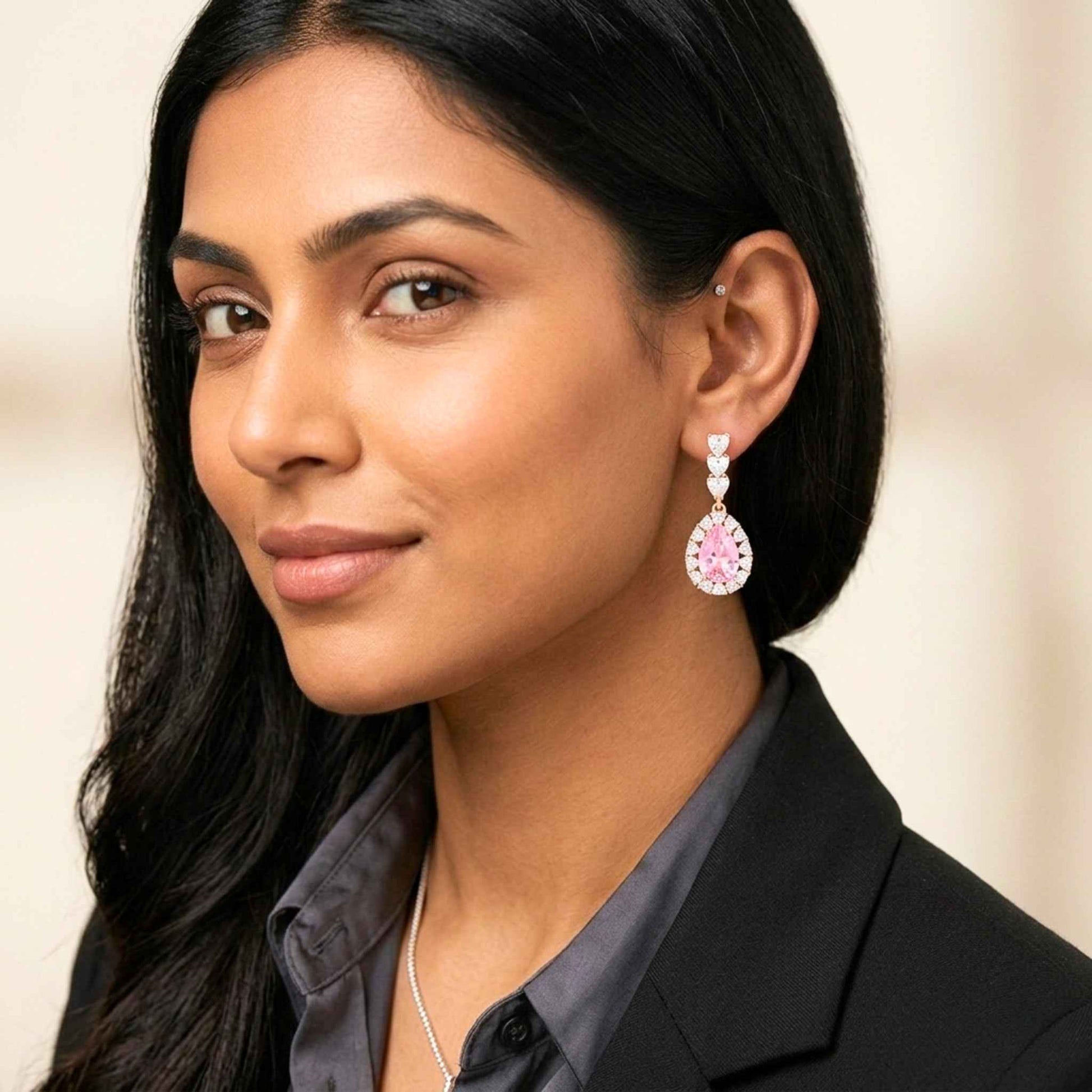 Woman wearing pink earrings with a neutral background.  Digitally rendered model for scale