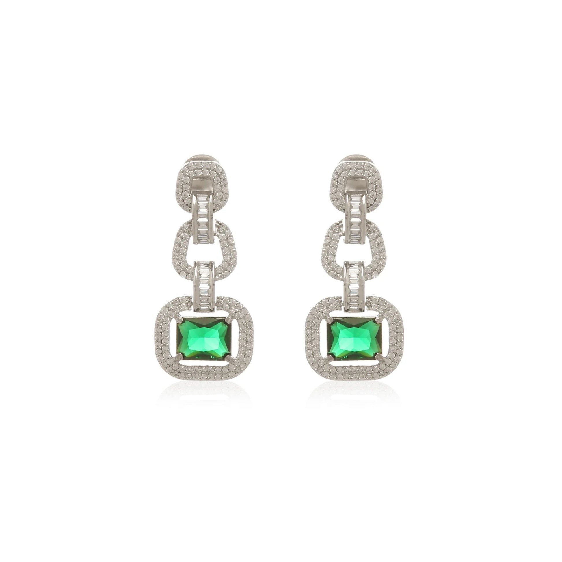 Pair of elegant white gold earrings with green gemstones on a white background