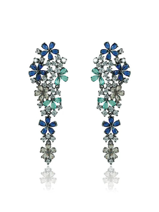 A pair of petal dangler earrings with polished rhodium finish and embellished with multi-colored zirconia stones in green and blue.