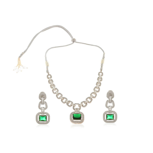 Jewellery set with necklace and earrings featuring green gemstones on a white background