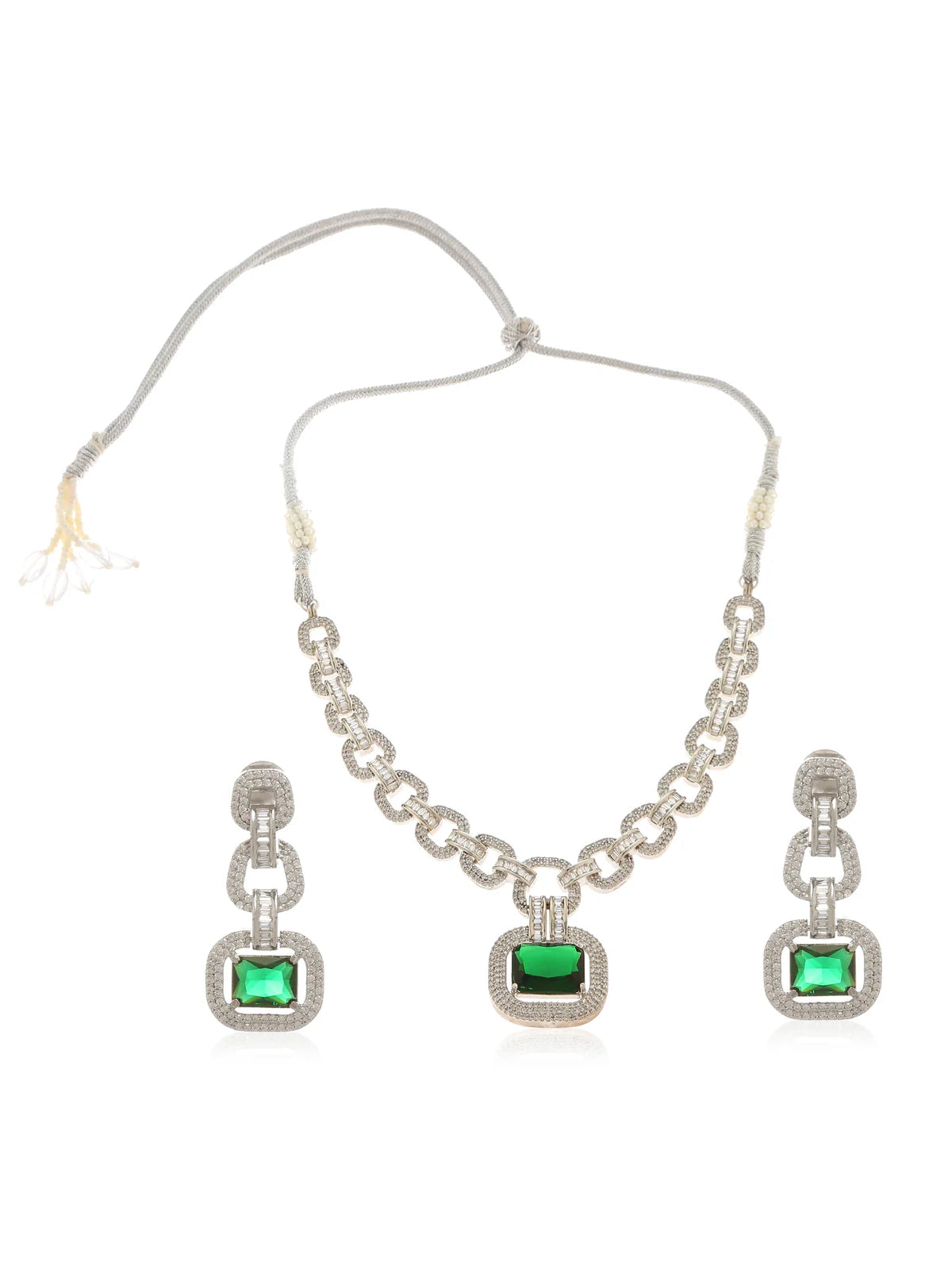 A white gold plated emerald necklace with zircon and emerald coloured stones, featuring an adjustable cord, and a pair of matching square earrings set against a white background.