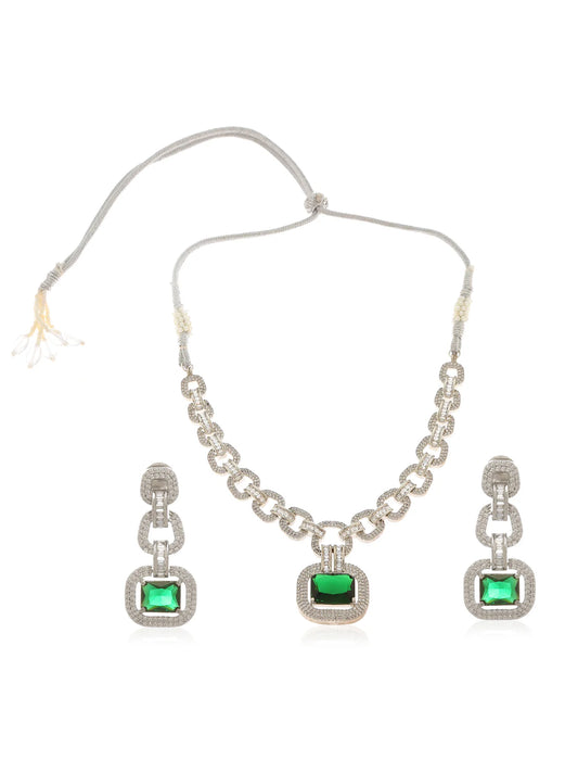 A white gold plated emerald necklace with zircon and emerald coloured stones, featuring an adjustable cord, and a pair of matching square earrings set against a white background.