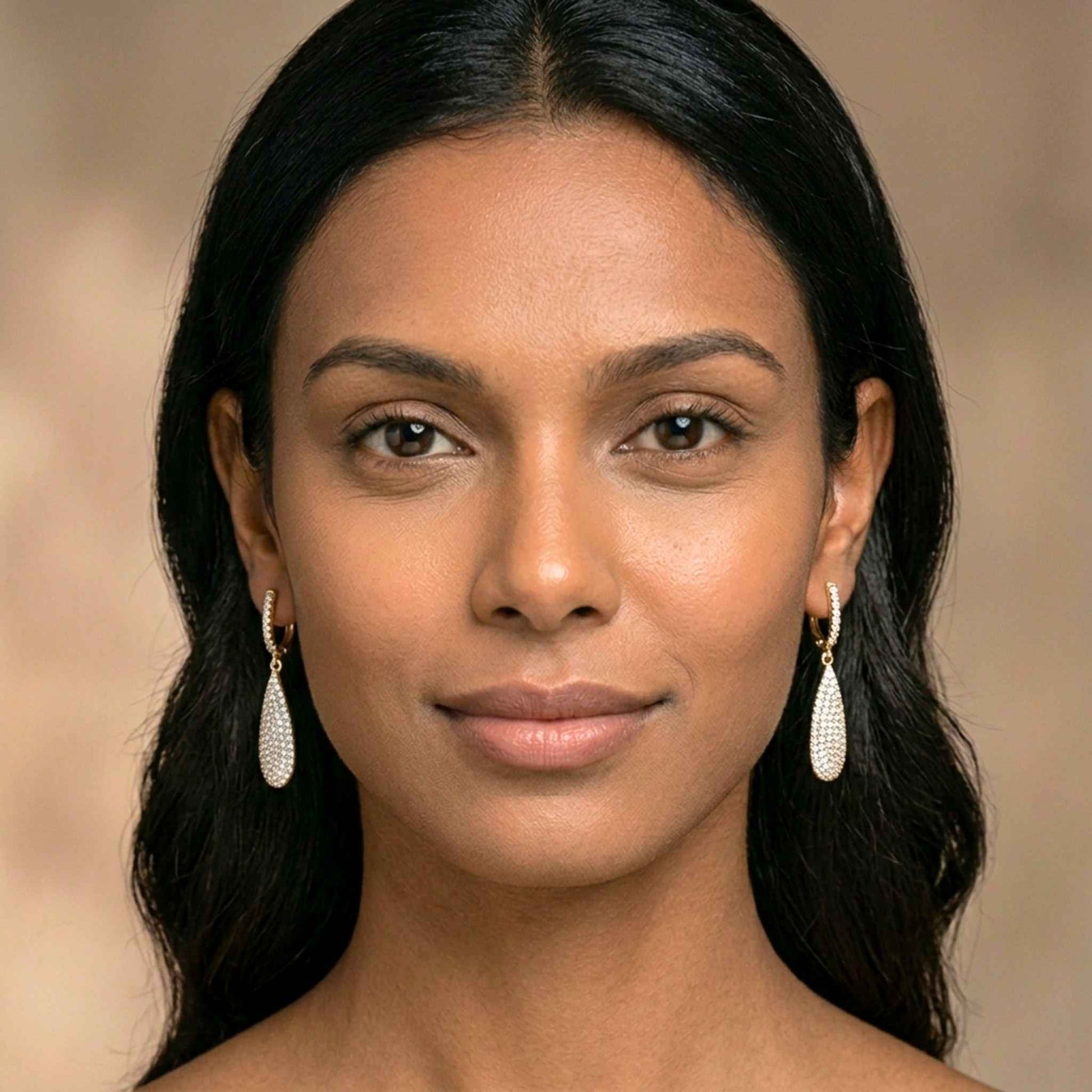 Woman wearing gold earrings with a blurred background.  Digitally rendered model for scale