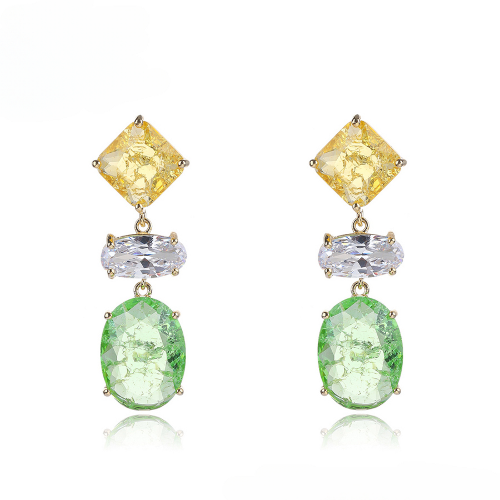 Pair of earrings with yellow, clear, and green gemstones on a white background