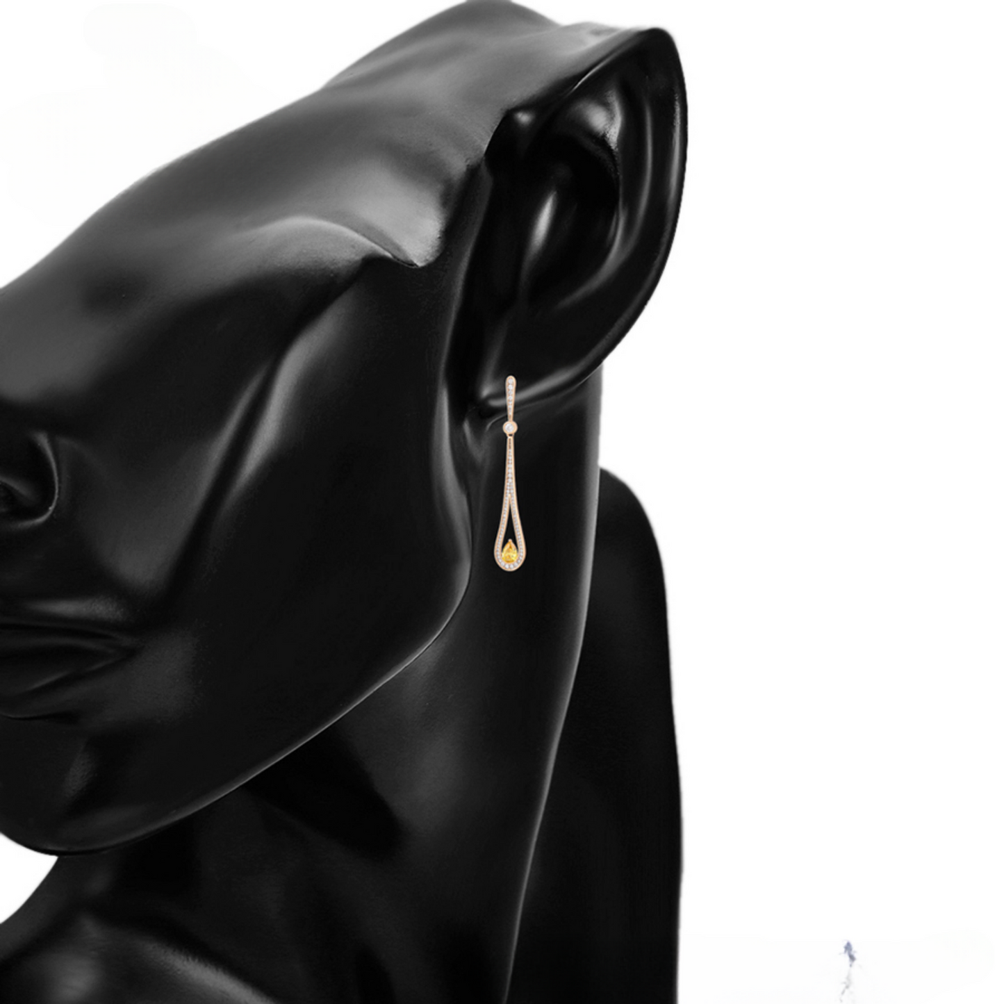 Gold earring on a model with a white background
