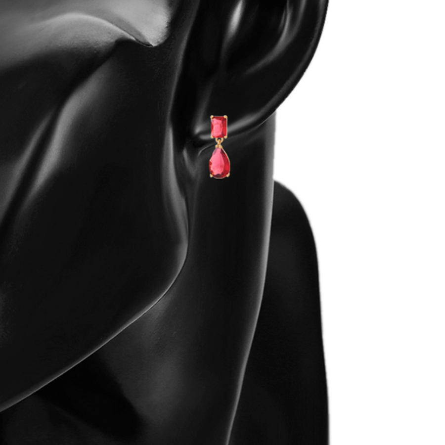 Red teardrop earrings on a model ear against a white background