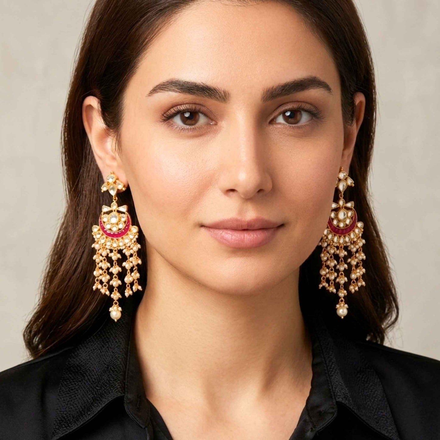 Woman wearing Gold earrings with red accents against a neutral background.  Digitally rendered model for scale