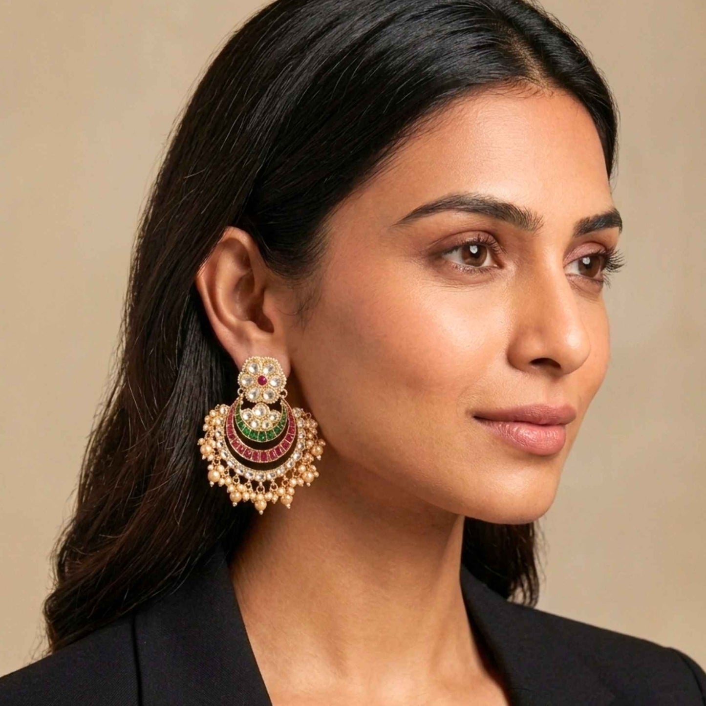 Woman wearing a pair of Indian ornate earrings for weddings with a neutral background.  Digitally rendered model for scale