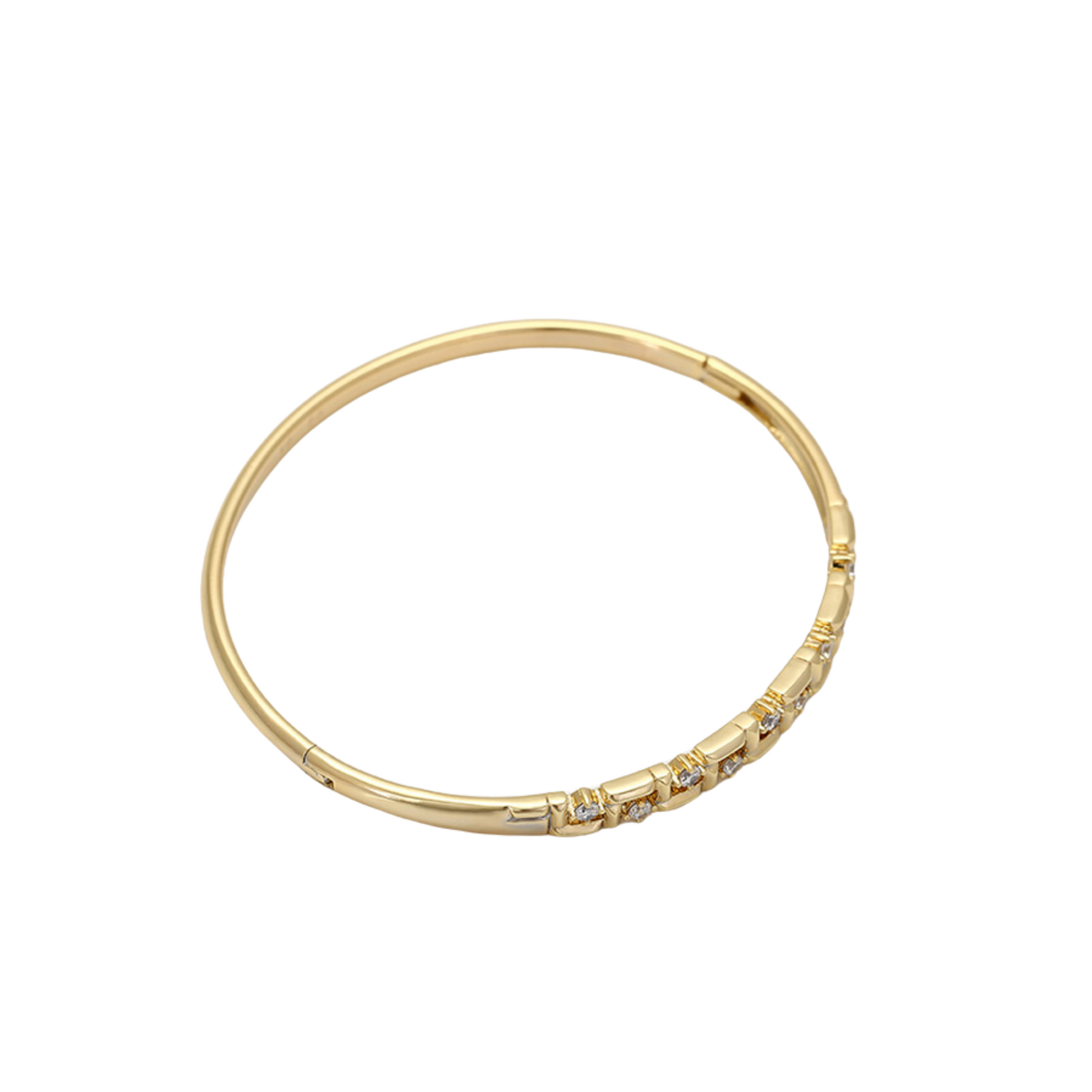 Gold bangle with embedded stones on a white background