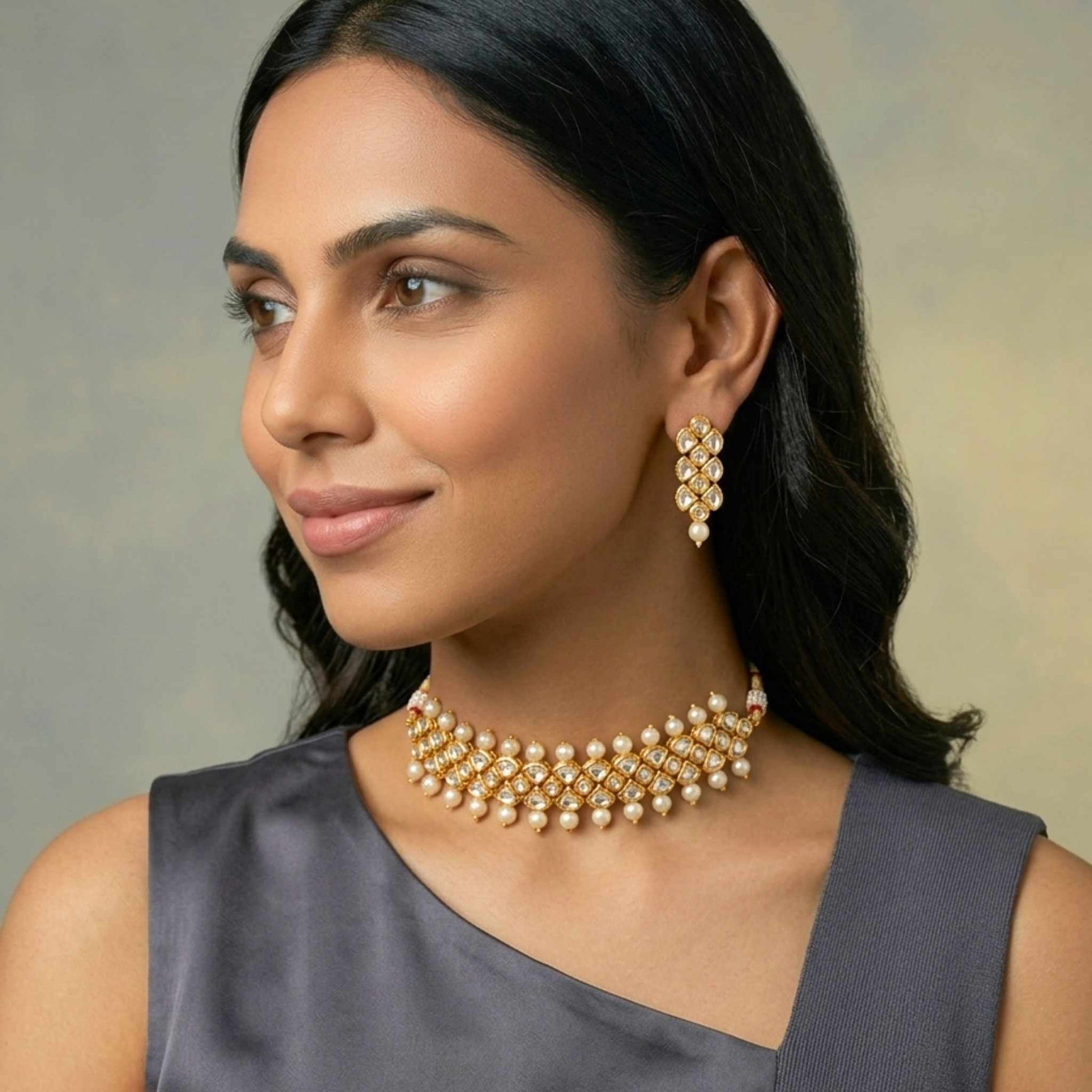 Woman wearing a gold necklace and earrings against a neutral background.  Digitally rendered model for scale