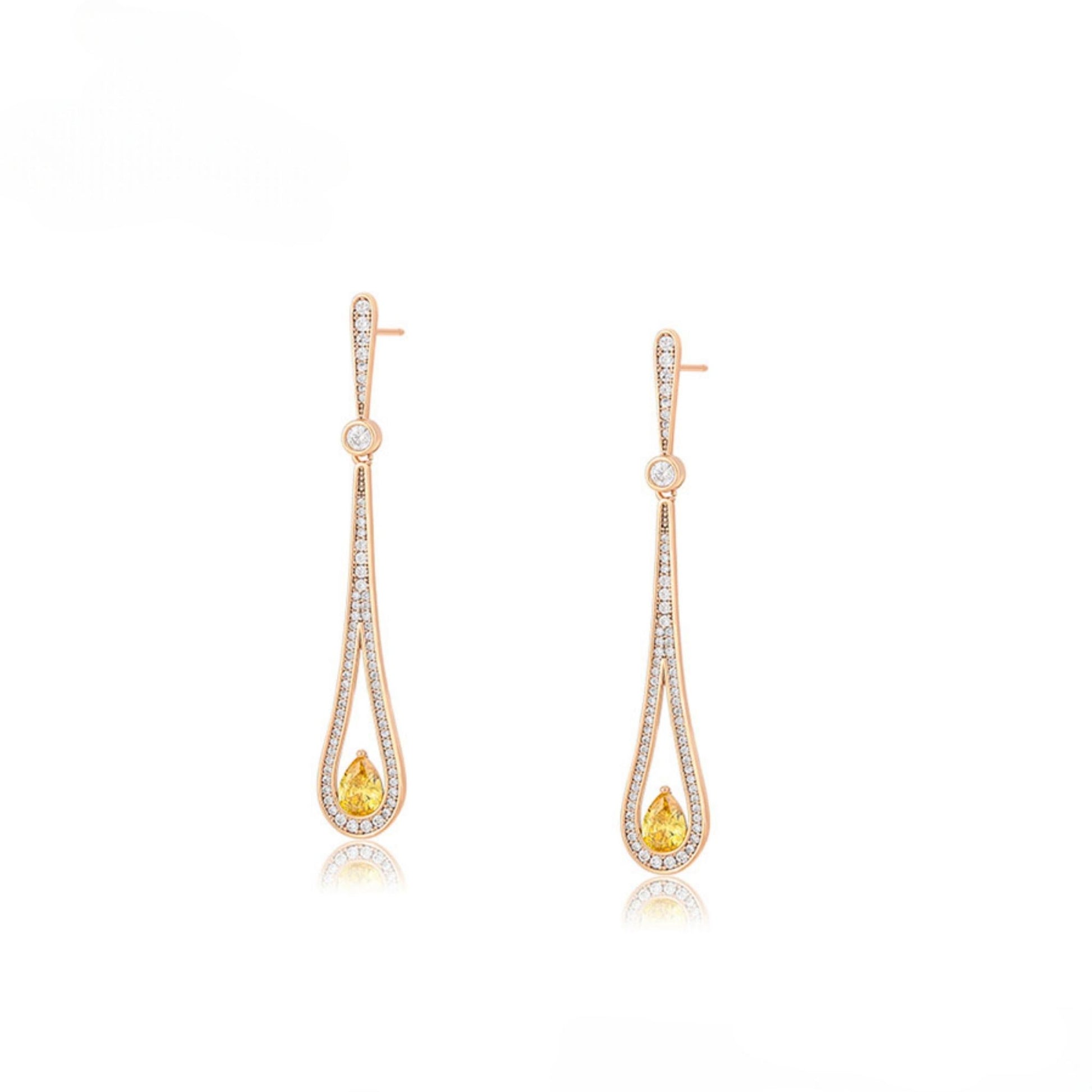 Pair of gold teat drop earrings with arrangement of clear gemstones and yellow gemstone.