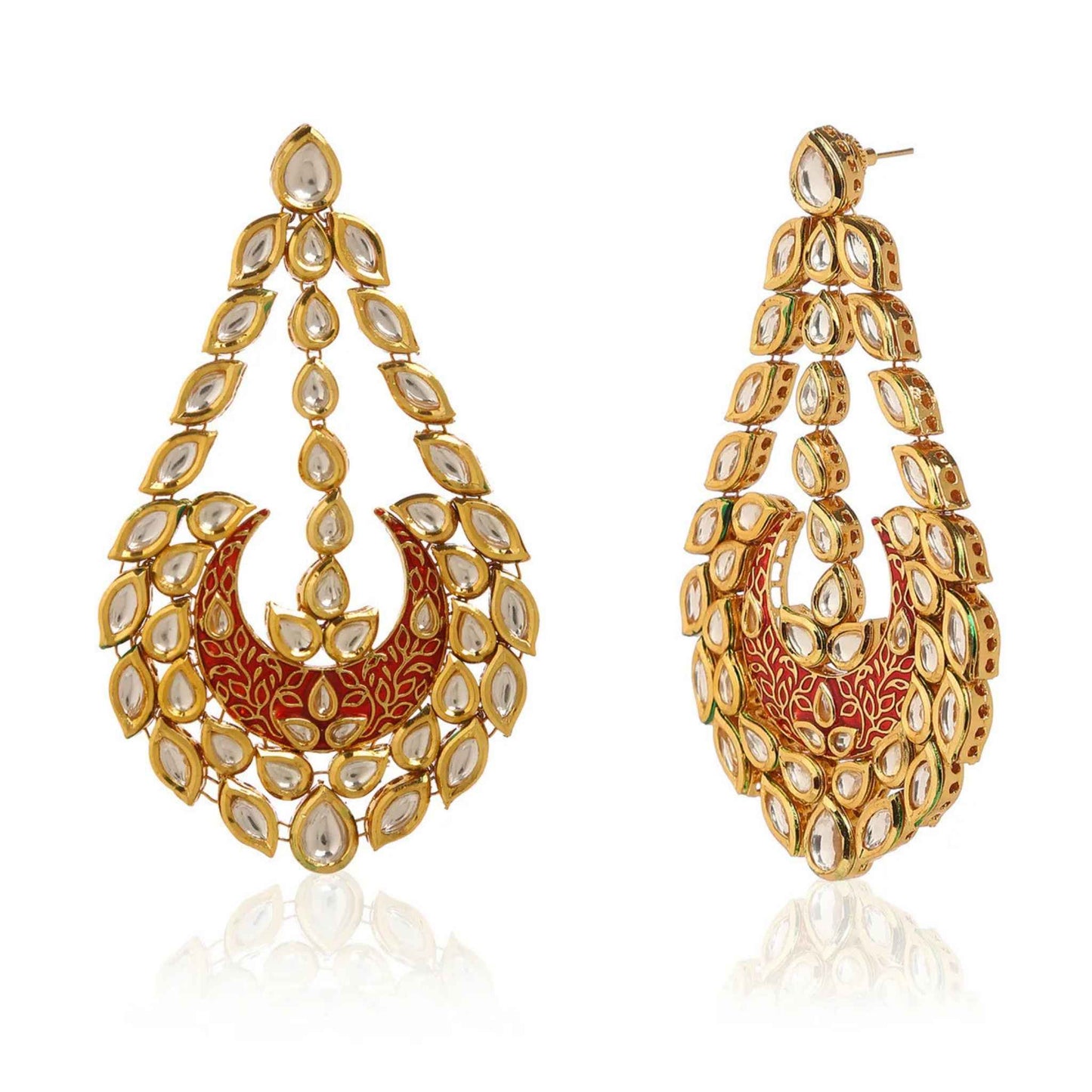 Ornate gold earrings with red crescent centre on a white background