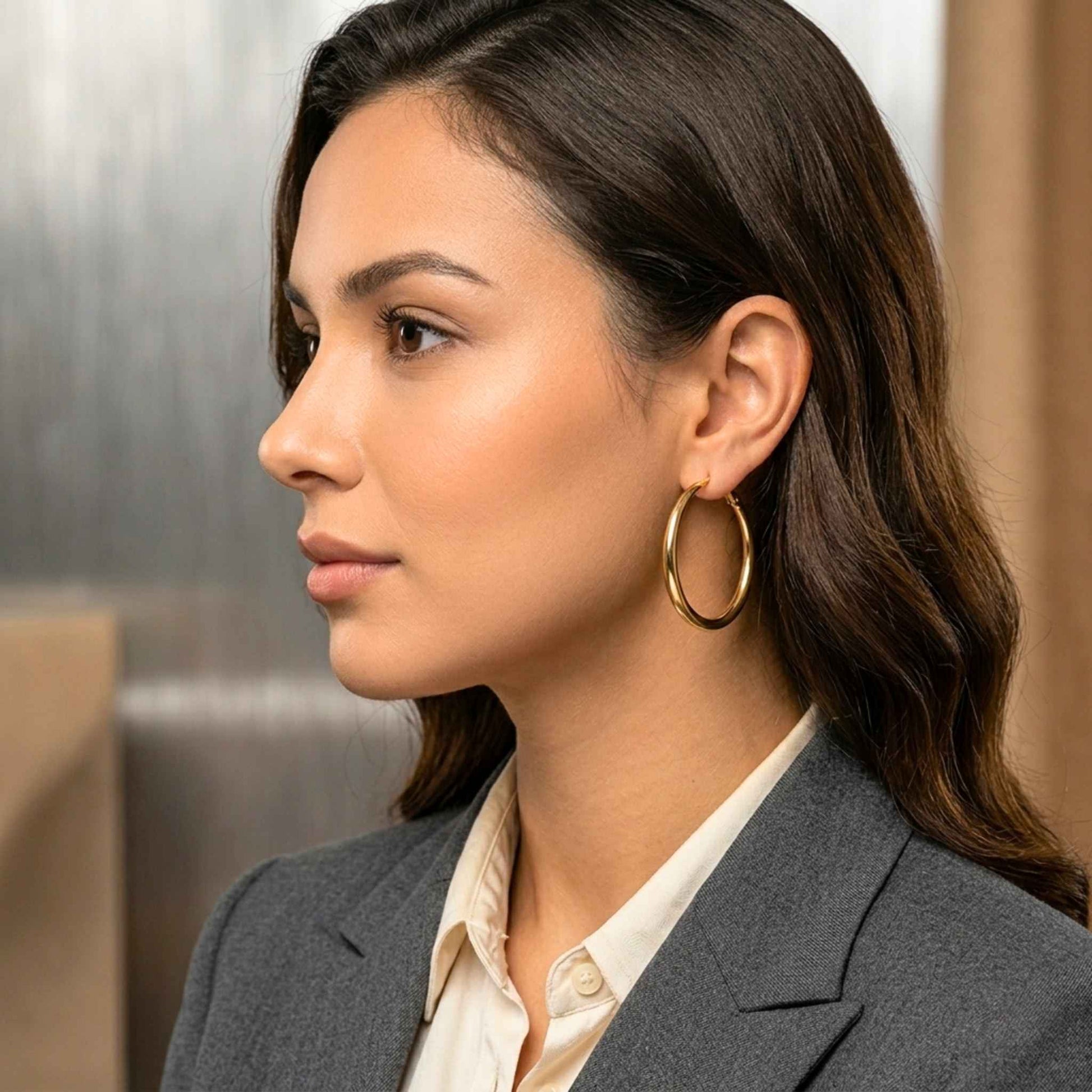Woman looking to the side with a large gold hoop.  Digitally rendered model for scale