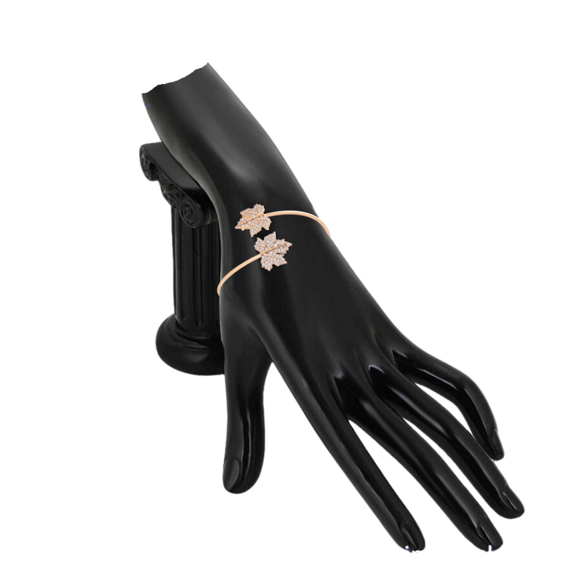 Model hand wearing a gold bracelet with leaf design on a white background