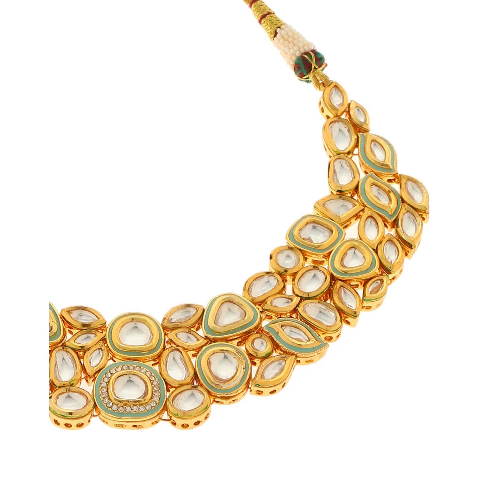 Gold necklace with clear stones on a white background