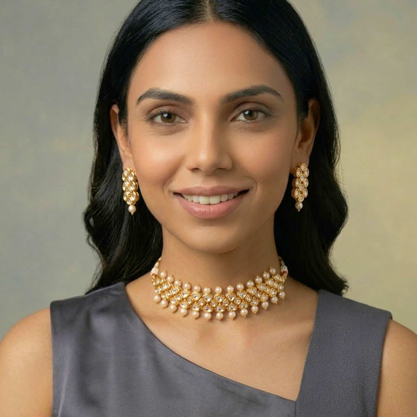 Woman wearing a gold necklace and earrings against a neutral background.  Digitally rendered model for scale