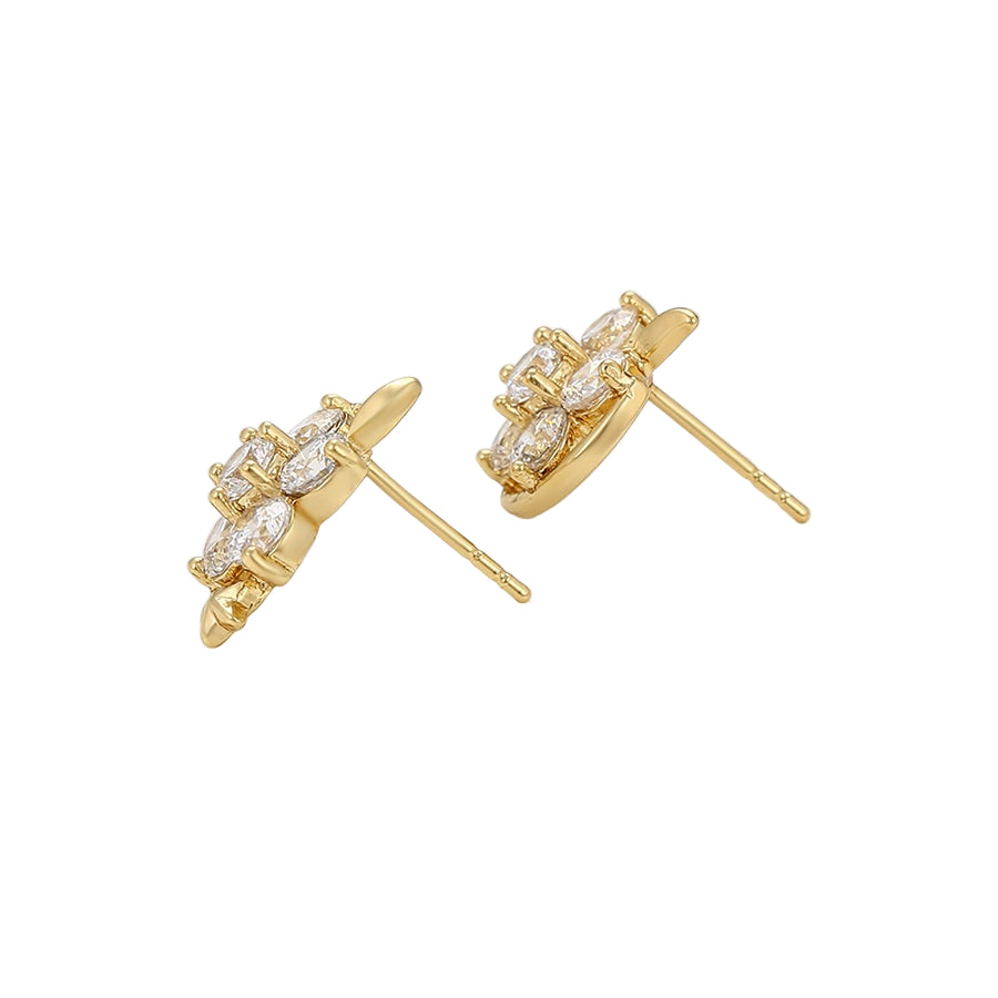 Gold earrings with clear gemstones on a white background