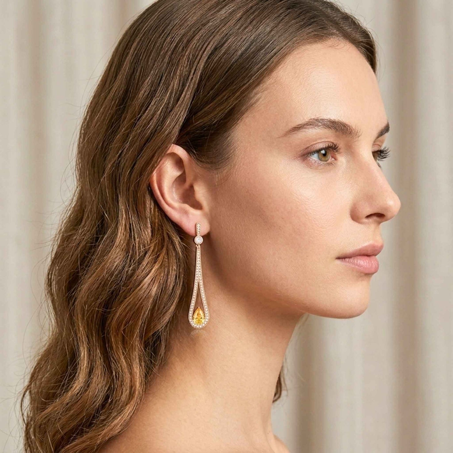 Woman wearing a pair of earrings with a neutral background.  Digitally rendered model for scale.