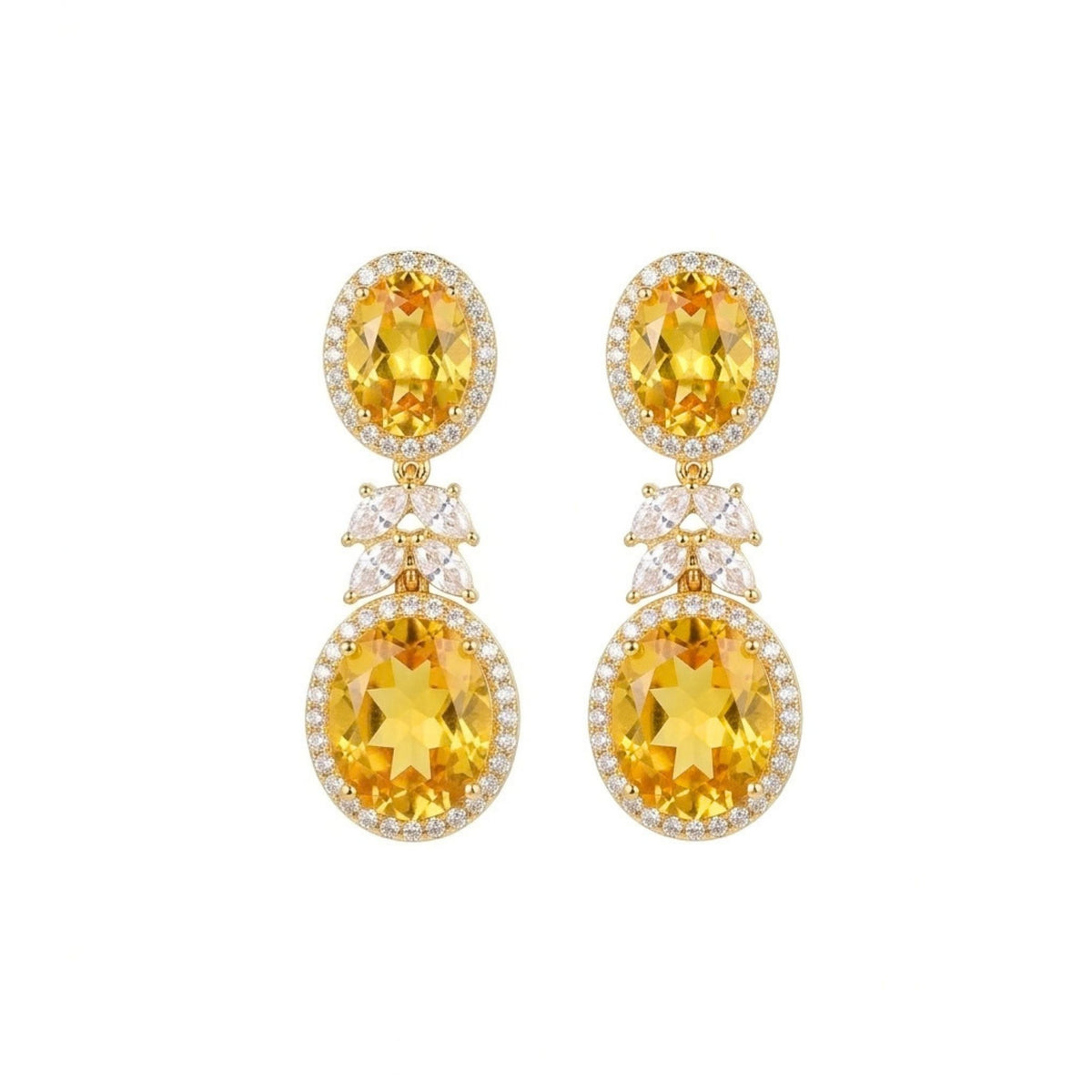 Pair of topaz coloured drop earrings with 2 oval topaz stones each of which surrounded by clear small stones from the Jewellery 4 Elegance collection, set against a white background.