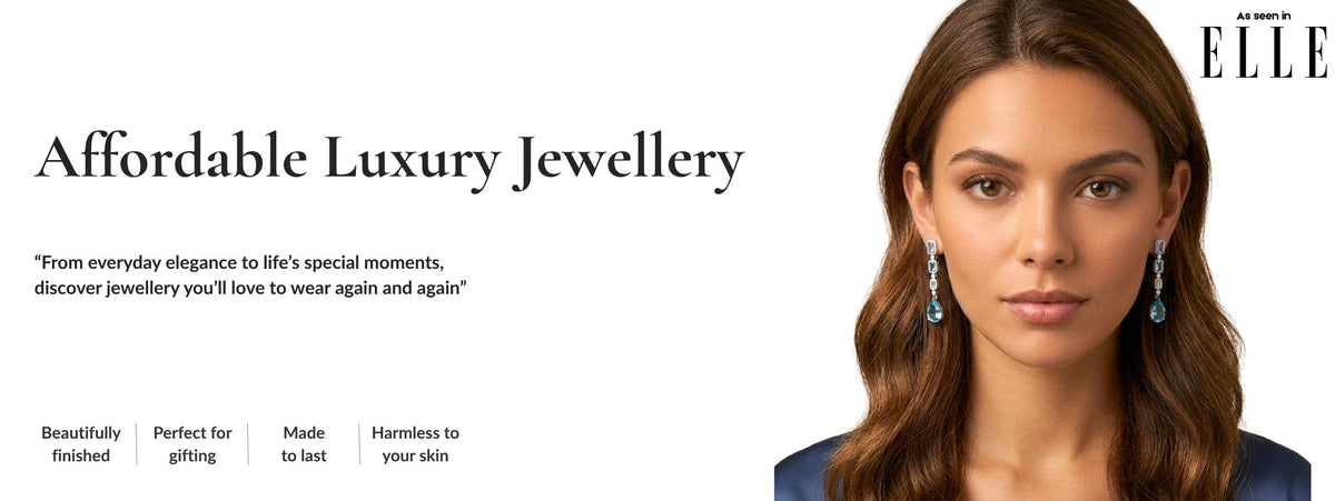 A promotional banner for Jewellery 4 Elegance featuring a woman with long brown hair wearing long, dangling blue teardrop earrings. The left side contains the text 'Affordable Luxury Jewellery' and marketing copy, while the right side shows a close-up portrait of the model against a white background.
